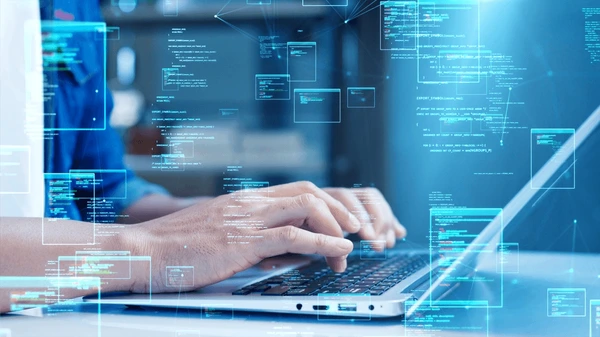 Developer writing PHP code on laptop